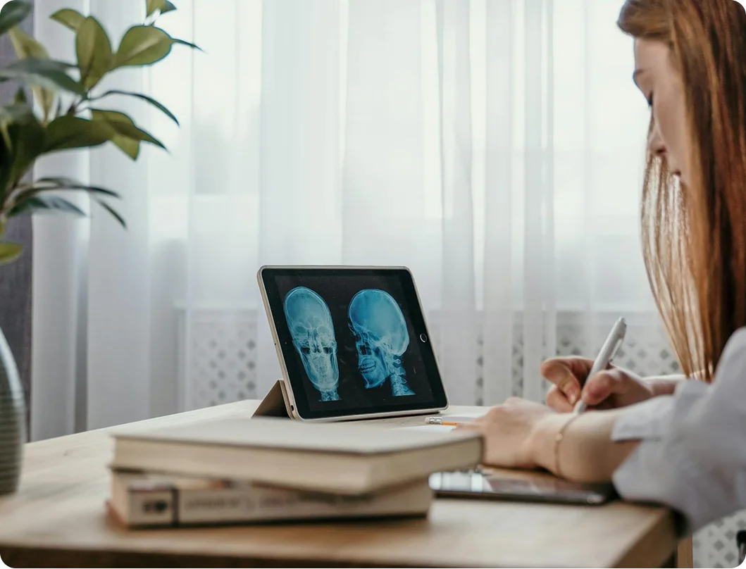 Chiropractor reviewing spine X-rays on a tablet